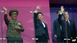 North Korean officials, including National Defense Commission Vice Chairman Hwang Pyong So, left, wave as their team marches into the stadium during the closing ceremony of the 17th Asian Games in Incheon, South Korea, Oct. 4, 2014.