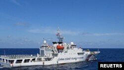 Sebuah kapal Garda Pantai China bermanuver di dekat kapal Penjaga Pantai Filipina BRP Teresa Magbanua dekat Scarborough Shoal di Laut China Selatan, Filipina, 8 Februari 2024. (Foto: via Reuters)
​
