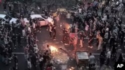 FILE - Iranians protest the death of Mahsa Amini, 22, after she was detained by the morality police, in Tehran, Sept. 20, 2022, in this photo taken by an individual not employed by The Associated Press and obtained by the AP outside Iran.