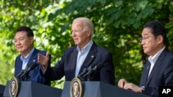 FILE - President Joe Biden speaks with Japanese Prime Minister Fumio Kishida, right, and South Korean President Yoon Suk Yeol during a joint news conference, Aug. 18, 2023, at Camp David in Maryland.