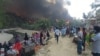 Rohingya refugees bring out their belongings and watch as fire guts through shanties in Balukhali refugee camp in Bangladesh, March 5, 2023.
