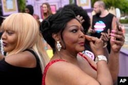 Tiffany Arieagus applies make-up before participating in the Stonewall Pride Parade on June 17, 2023, in Wilton Manors, Florida.