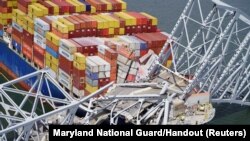 FILE - Aerial view of the Dali cargo vessel which crashed into the Francis Scott Key Bridge, causing it to collapse in Baltimore, Maryland, March 26, 2024.