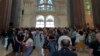Visitors look around the main temple of the Sagrada Familia, Oct. 6, 2023. (Graham Keeley/VOA)