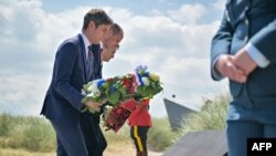 French Prime Minister Gabriel Attal (L), Britain's Prince William (C) and Canadian Prime Minister Justin Trudeau (R) lay a wreath during the 80th anniversary of the World War II "D-Day" Allied landings in Normandy, at the Juno Beach Centre in northwestern France, June 6, 2024. 