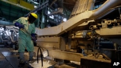FILE - An Iranian man works at the Mobarakeh Steel Complex on May 31, 2012. Thousands of steelworkers went on strike Dec. 2, 2023, against the Isfahan Steel Company, seeking wages more in line with those in other steel companies, including Mobarakeh.