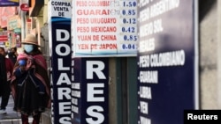 FILE - People walk near a currency exchange point, in La Paz, Bolivia, March 6, 2023. 