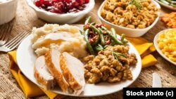 A traditional American Christmas meal often includes turkey, potatoes, stuffing and cranberry sauce.