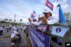 FILE - Cambodia's Candlelight Party supporters participate in marching during an election campaign for the June 5 communal elections in Phnom Penh, Cambodia, Saturday, May 21, 2022.