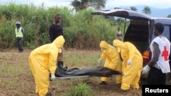 FILE - Health workers carry the body of an Ebola virus victim in the Waterloo district of Freetown, Sierra Leone. Burial teams are vulnerable to psychological stress. 