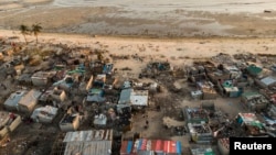 FILE - Debris and destroyed buildings are all that remain after Cyclone Idai hit the Praia Nova neighborhood in Beira, Mozambique, April 1, 2019.