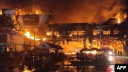 Firefighters and rescue workers gather at the site of a fire at the Grand Diamond City hotel-casino in Poipet, Cambodia, on Dec. 29, 2022. 