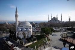 A view of the Sultan Ahmed Mosque, right, better known as the Blue Mosque in the historic Sultanahmet district of Istanbul, the area of an explosion, Jan. 12, 2016.