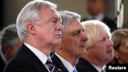 (L-R) David Davies Secretary of State for Exiting the European Union, Chancellor of the Exchequer Philip Hammond and Foreign Secretary Boris Johnson listen Britain's Prime Minister Theresa May as she gives a speech in Complesso Santa Maria Novella, Floren