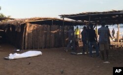 A body lays on the beach were gunmen attacked people in Grand Bassam, Ivory Coast, March 13, 2016.