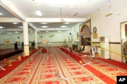 FILE - In this photo released by the Saudi Press Agency SPA, Saudi officials and investigators, background, check a mosque inside a police compound after a suicide bombing attack in of Abha, the provincial capital of Asir, Saudi Arabia, Aug. 6, 2015.