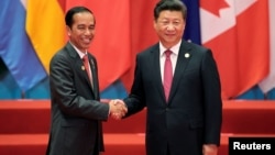 FILE - Chinese President Xi Jinping shakes hands with Indonesia's President Joko Widodo during the G20 Summit in Hangzhou, China, Sept. 4, 2016.