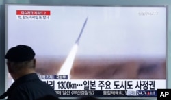 FILE - A man watches a TV screen showing file footage of the missile launch conducted by North Korea, at Seoul Railway Station in Seoul, South Korea, March 18, 2016.