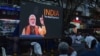 People watch the BBC documentary "India: The Modi Question", on a screen installed at the Marine Drive junction under the direction of the district Congress committee, in Kochi, Jan. 24, 2023.