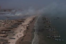 Fishing boats line the shore of Bargny beach, some 35 kilomters (22 miles) east of Dakar, Senegal, Thursday April 22, 2021.