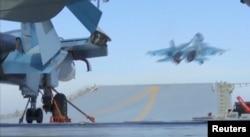 FILE - A still image taken from a video footage and released by Russia's Defense Ministry on Nov. 15, 2016, shows a jet taking off from Russian Admiral Kuznetsov aircraft carrier near the coast of Syria.