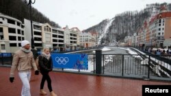 People walk at the Rosa Khutor Alpine Resort in Krasnaya Polyana near Sochi, Jan. 26, 2014. 