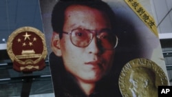The picture of Chinese dissident Liu Xiaobo is carried by a protester demanding the release of Liu Xiaobo outside the China's Liaison Office in Hong Kong, October 11, 2010.