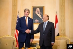 FILE - U.S. Secretary of State John Kerry, left, shakes hands with President of Yemen Abdu Rabu Mansour Hadi, for photographs, at the Al-Nasarieh Guest Palace in Riyadh, Saudi Arabia, May 7, 2015.
