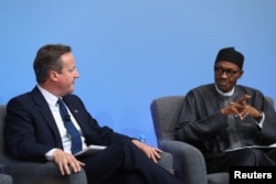 Nigerian President Muhammadu Buhari listens as British Prime Minister Cameron opens the international anti-corruption summit on May 12, 2016 in London, England.