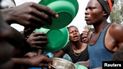 Internally displaced people wait for food distribution at an internally displaced persons (IDP) camp in Bunia, Ituri province, eastern Democratic Republic of Congo, April 12, 2018.