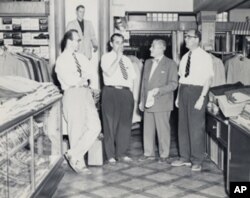 Howard Miller (left) with family members in the men's casual pants department, believed to have been taken in the 1950s.