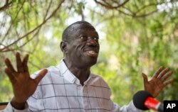 FILE - Opposition leader and presidential candidate Kizza Besigye speaks to the media while under continued house arrest, at his home in Kasangati, outside the capital Kampala, in Uganda, Feb. 21, 2016.