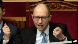 FILE - Ukrainian Prime Minister Arseniy Yatsenyuk speaks to lawmakers during a session at the Ukrainian parliament in Kiev, Ukraine, April 18, 2014.