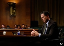FILE - Then-FBI Director James Comey pauses as he testifies on Capitol Hill in Washington, before a Senate Judiciary Committee hearing, May 3, 2017.