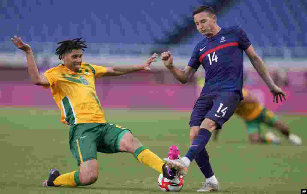 France's FlorianThauvin, right, and Luke Fleurs of South Africa battle for the ball during a men's soccer match at the 2020 Summer Olympics, Sunday, July 25, 2021, in Saitama, Japan. (AP Photo/Martin Mejia)