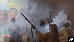 Des chasseurs traditionnels dogon accueille le candidat à la présidentielle Ibrahim Boubacar Keita avec des coups de feu à Bandiagara, Mali, le 21 juillet 2013.