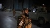 Taliban fighters block roads after an explosion Tuesday, Nov. 2, 2021. An explosion went off Tuesday at the entrance of a military hospital in Kabul, killing several people and wounding over a dozen, health officials said.