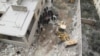 Civil defense workers remove dead bodies from under debris after an airstrike on Kafr Hamra village in the northern Aleppo countryside of Syria, Feb. 27, 2016.