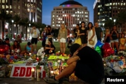 FILE - Local resident Jean Dasilva mourns for his deceased friend Javier Jorge-Reyes at a makeshift memorial in downtown Orlando for victims of the gay nightclub shooting, in Orlando, Florida, June 14, 2016.
