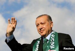 Turkish President Tayyip Erdogan greets his supporters during a ceremony in Konya, Turkey, Oct. 28, 2017.
