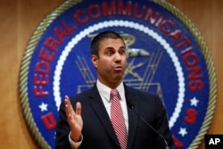 After a meeting voting to end net neutrality, Federal Communications Commission Chairman Ajit Pai answers a question from a reporter,, Dec. 14, 2017, in Washington.