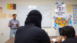 Afghan refugees take a class at the Fort McCoy, Wis., U.S. Army base, Sept. 30, 2021. The fort is one of eight military installations across the country that are temporarily housing the tens of thousands of Afghans who fled their homeland in August.