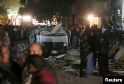 Damaged cars are seen at the scene of a bomb blast in Giza, Egypt, Jan. 21, 2016.