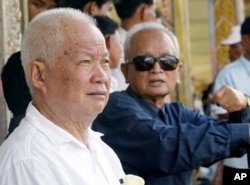 រូបឯកសារ៖ ខៀវ សំផន (ឆ្វេង) និងនួន ជា (ស្តាំ) មុនពេលតុលាការខ្មែរក្រហមបានចោទប្រកាន់ពួកគេ នៅខេត្តប៉ៃលិន ថ្ងៃទី៣ ខែកក្កដា ឆ្នាំ២០០៣។