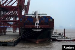 FILE - A cargo ship is anchored at a port in Zhoushan, Zhejiang province, Feb. 14, 2016.