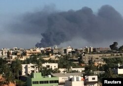 Smoke rises during a fight between members of the Libyan internationally recognized government forces and Eastern forces in Ain Zara, Tripoli, Libya, May 5, 2019.