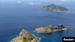 FILE - A group of disputed islands, Uotsuri island (top), Minamikojima (bottom) and Kitakojima, known as Senkaku in Japan and Diaoyu in China is seen in the East China Sea, in this photo taken by Kyodo September 2012.