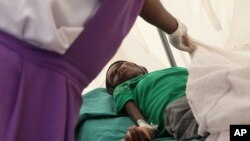 A patient suffering from HIV is taken to a local hospital in Harare, January 31, 2012.