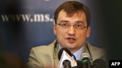 FILE - Polish Justice Minister Zbigniew Ziobro listens to a question during a press conference in Warsaw. On July 12, 2017, he criticized the current makeup of the National Judiciary Council as undemocratic.