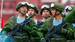FILE - Russian paratroopers march the Victory Day military parade in Red Square marking the 76th anniversary of the end of World War II in Europe in Moscow, May 9, 2021. The amassing of Russian troops and equipment near Ukraine's border has caused worries in Kyiv and in the West that Moscow could be planning to launch an invasion.